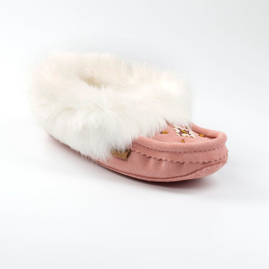 Pink moccasin slipper with white fur on a white background