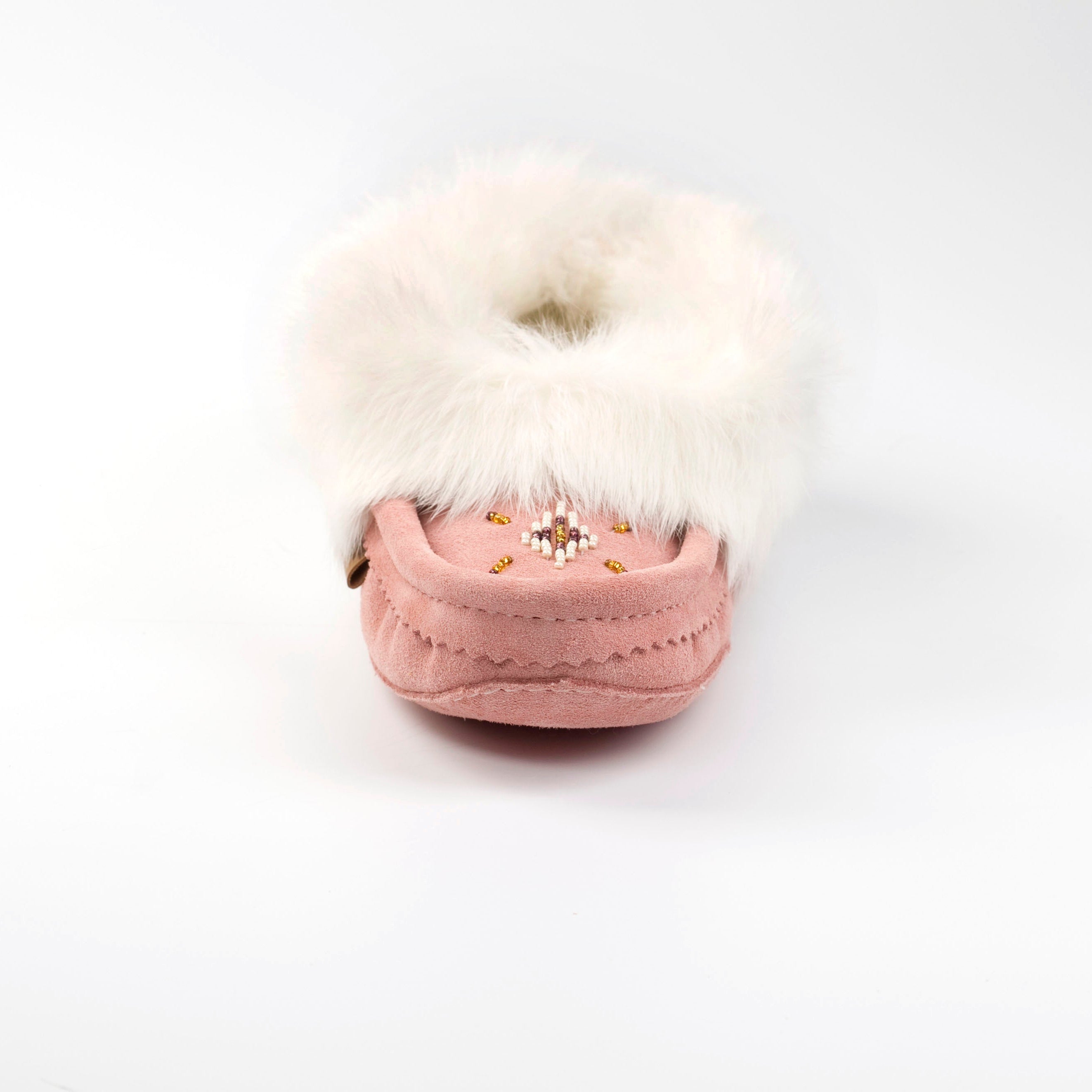 Pink slipper with white fur on a white background
