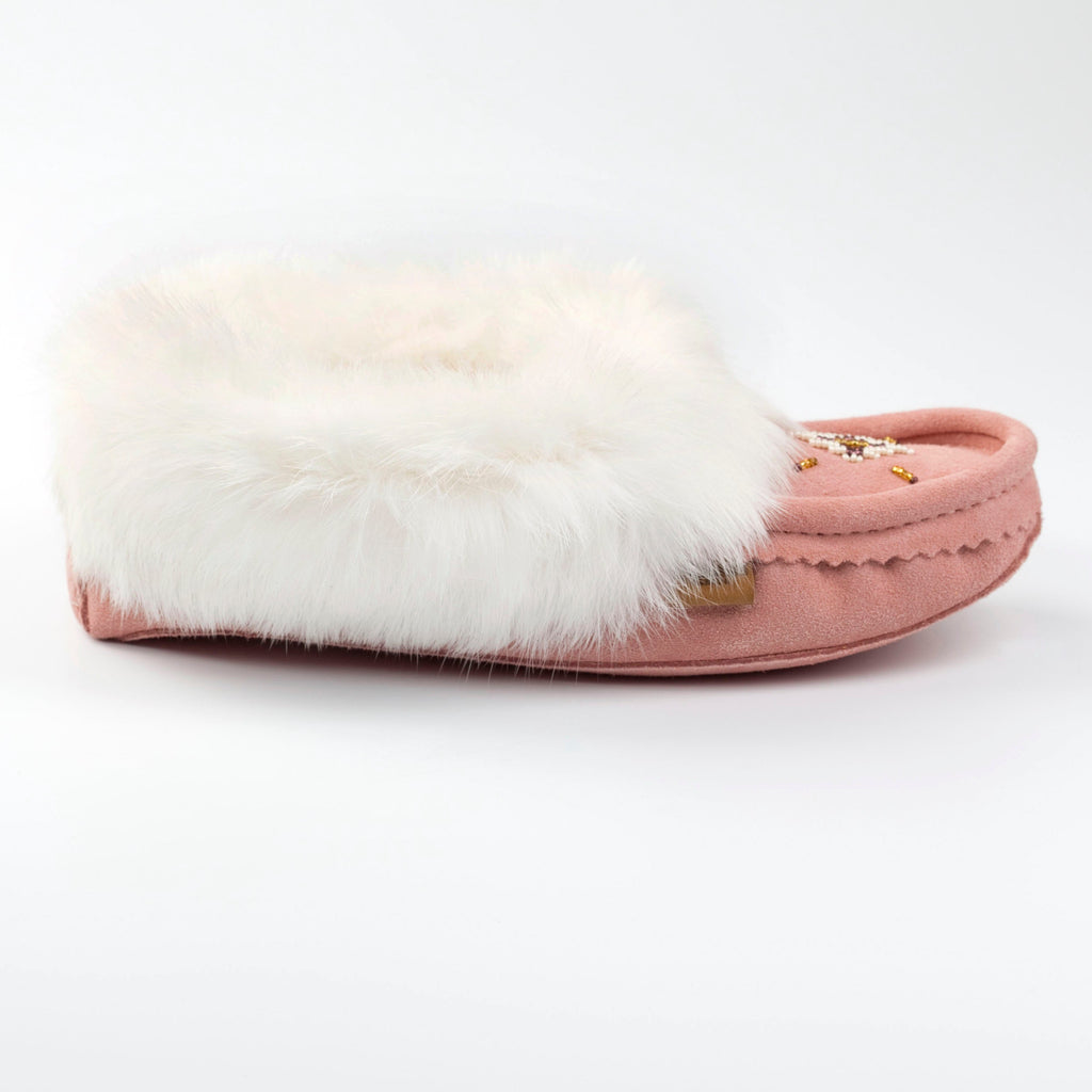 Pink slipper with white fur on a white background