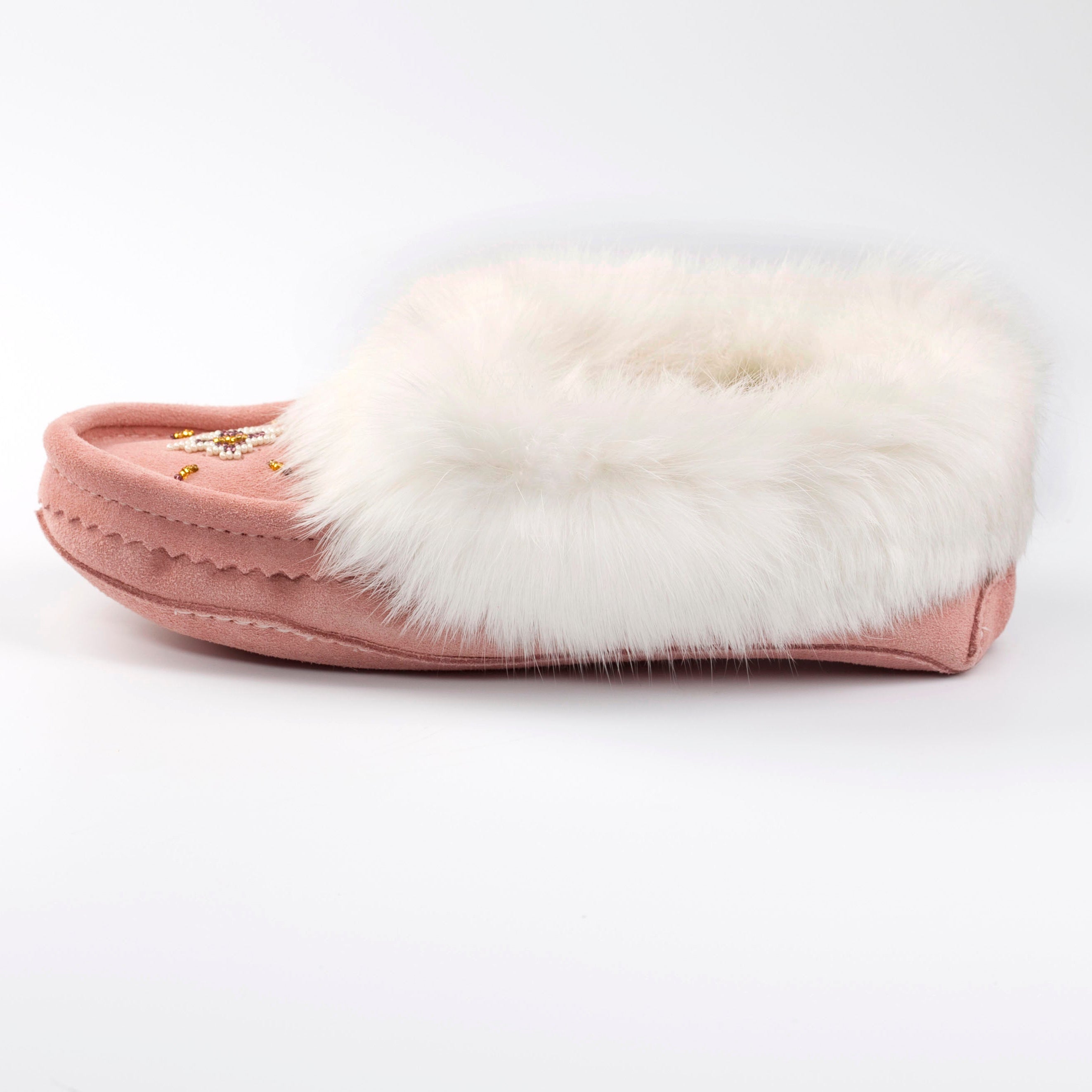 Pink slipper with white fur on a white background