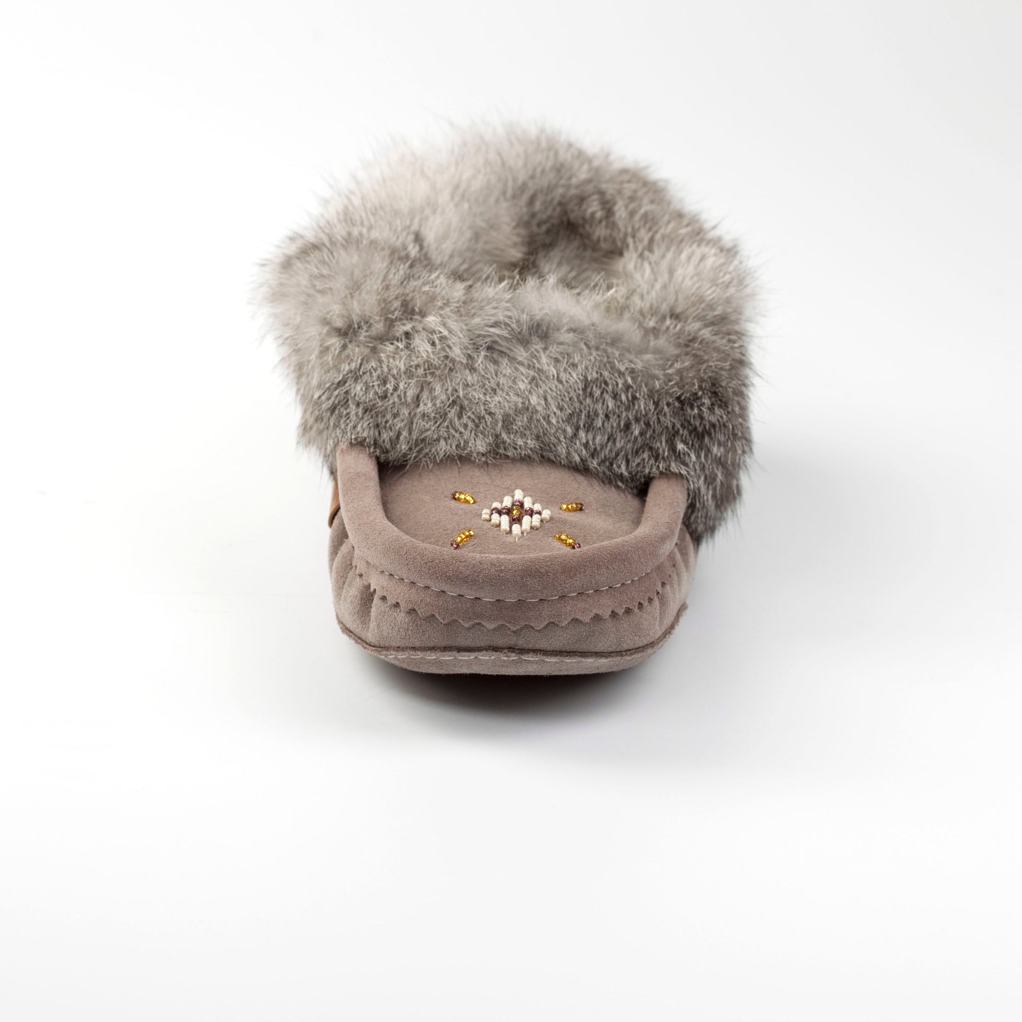 Gray moccasin with fur on a white background