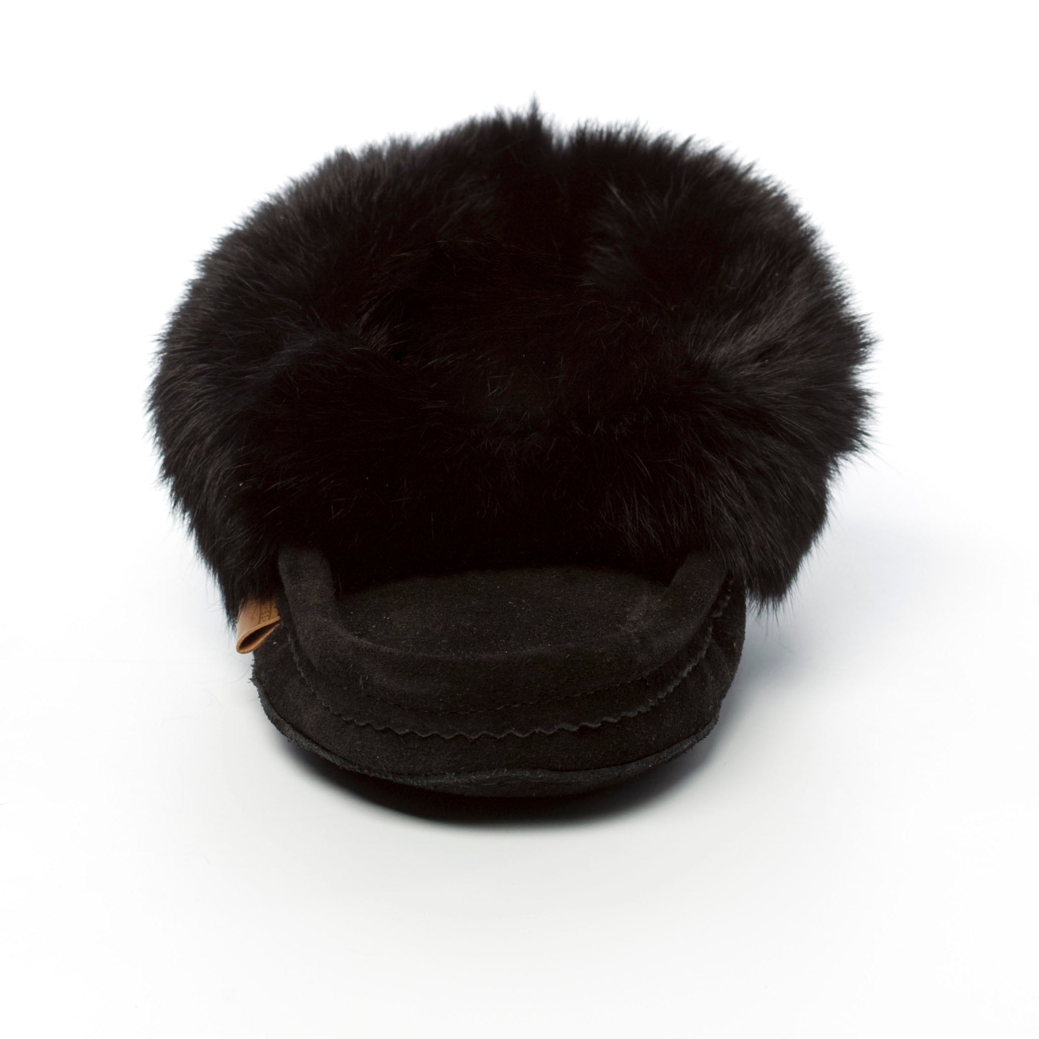 Black fur-lined slipper on a white background