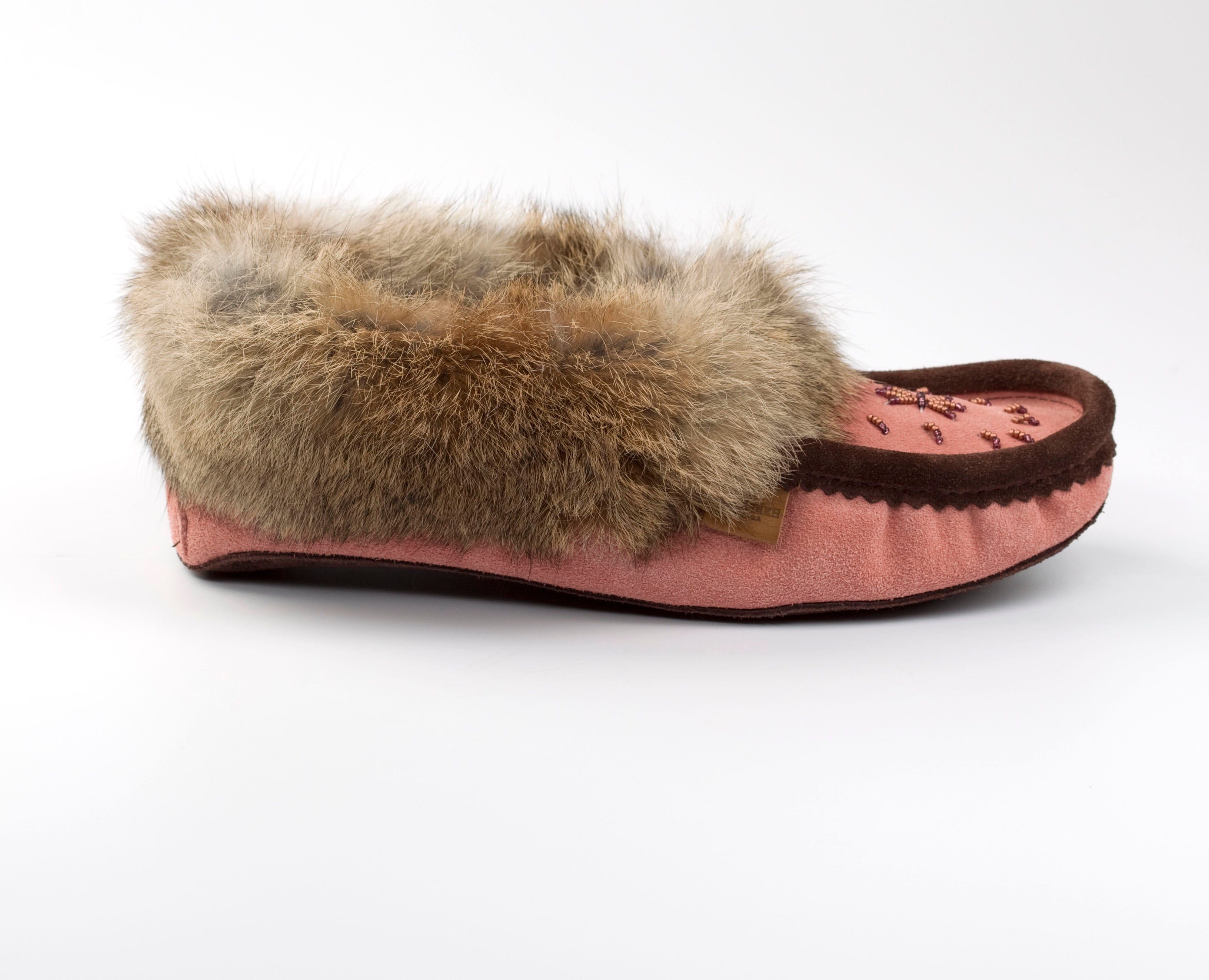 Pink slipper with fur trim on a white background