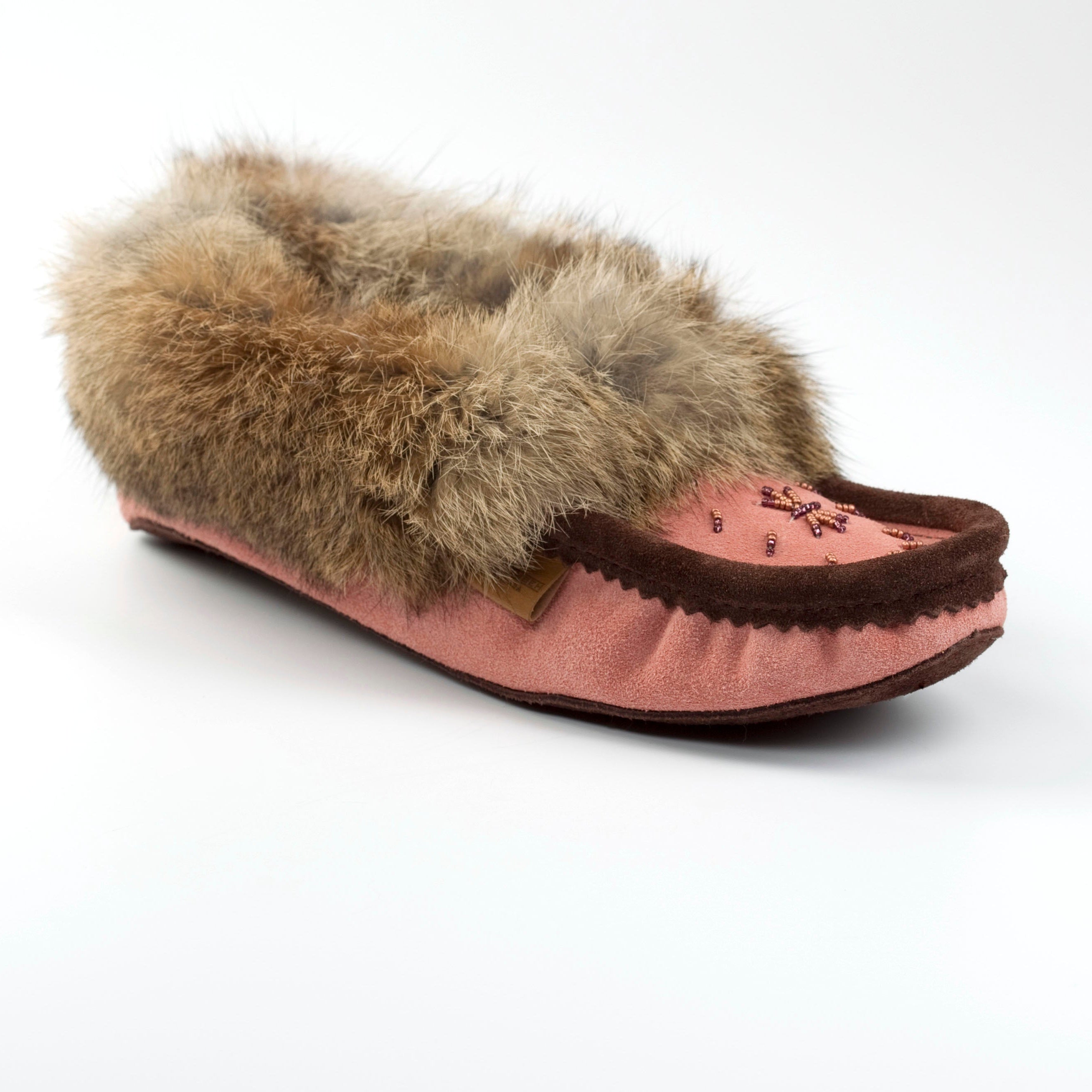 Pink slipper with brown fur trim on a white background