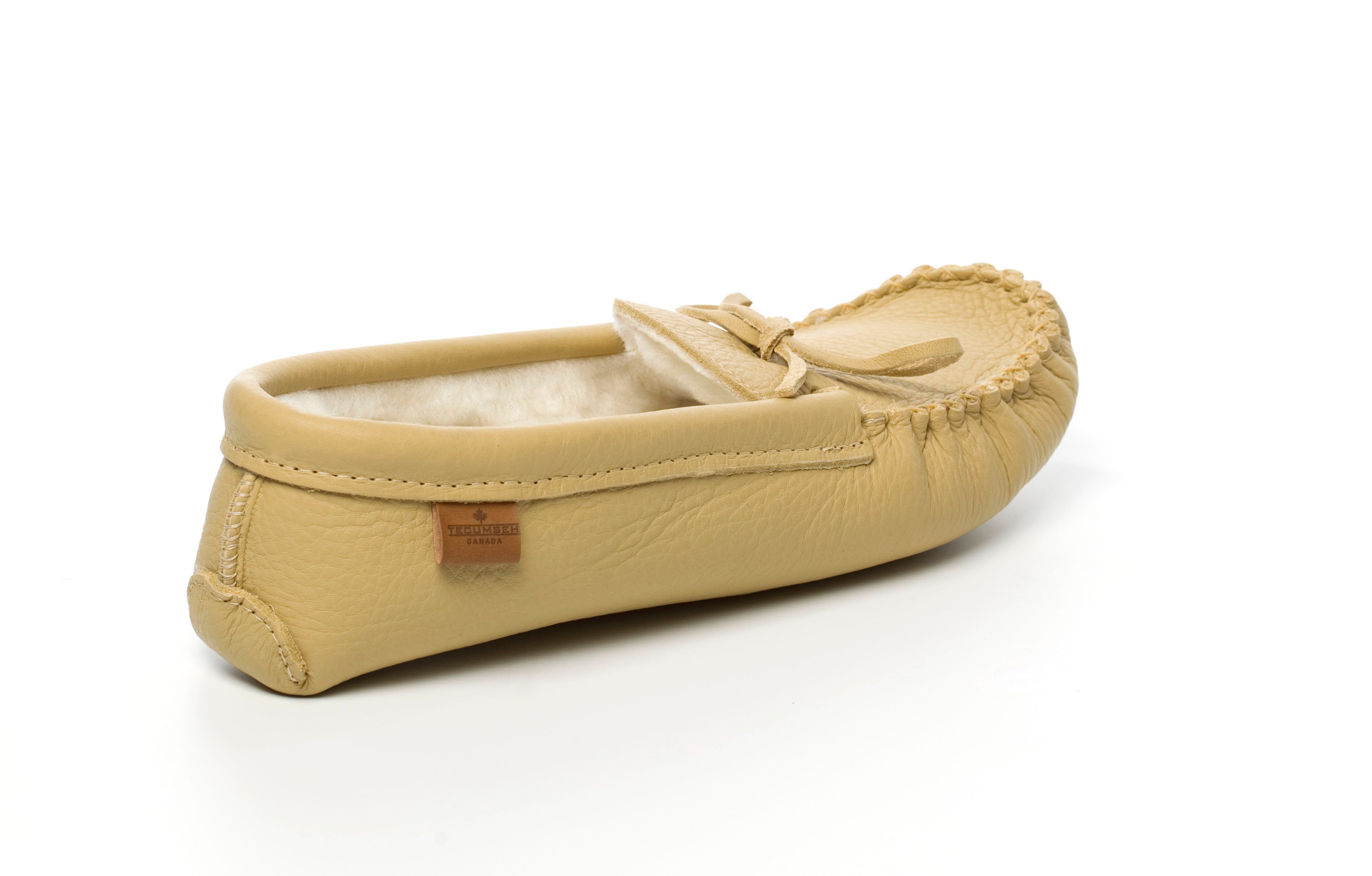 Beige moosehide moccasin slipper on a white background