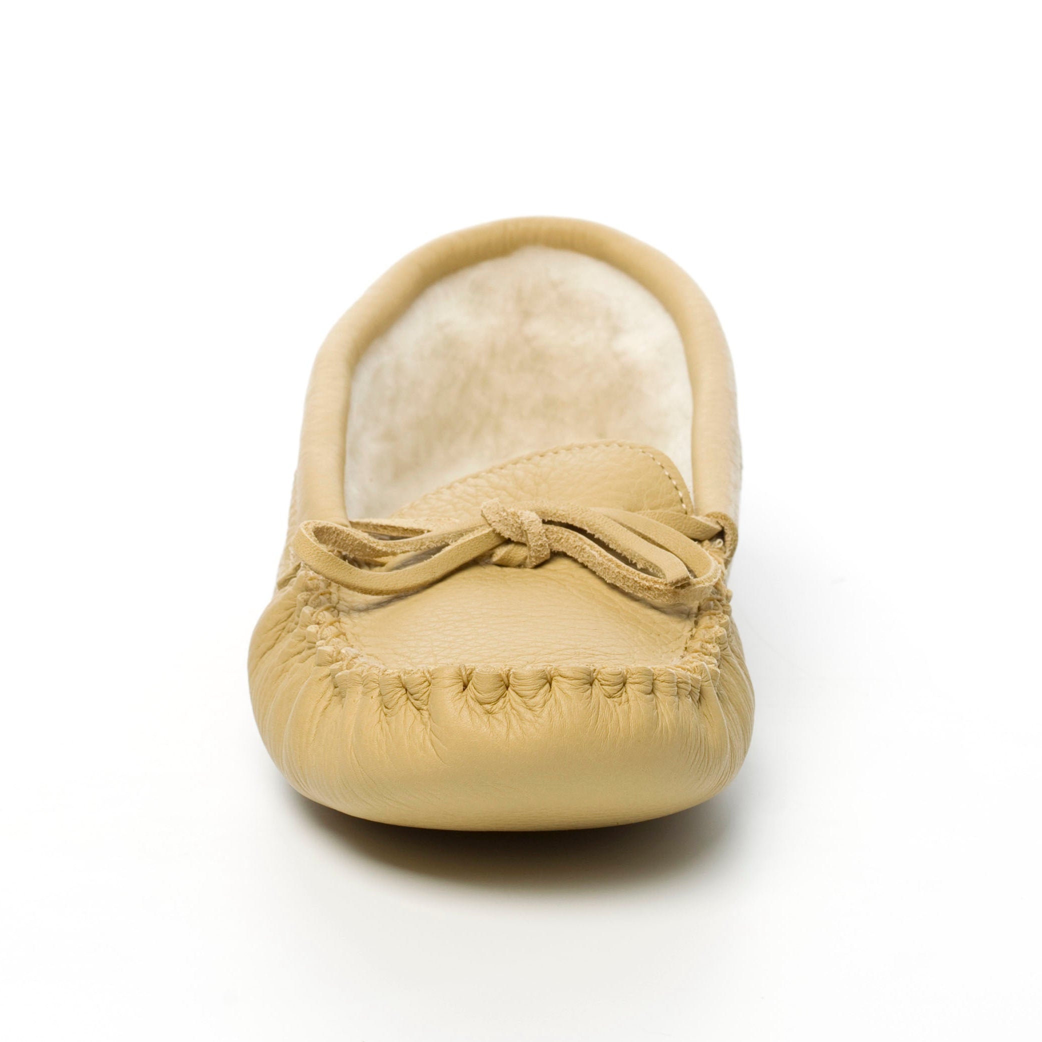 Beige moccasin slipper with bow on a white background