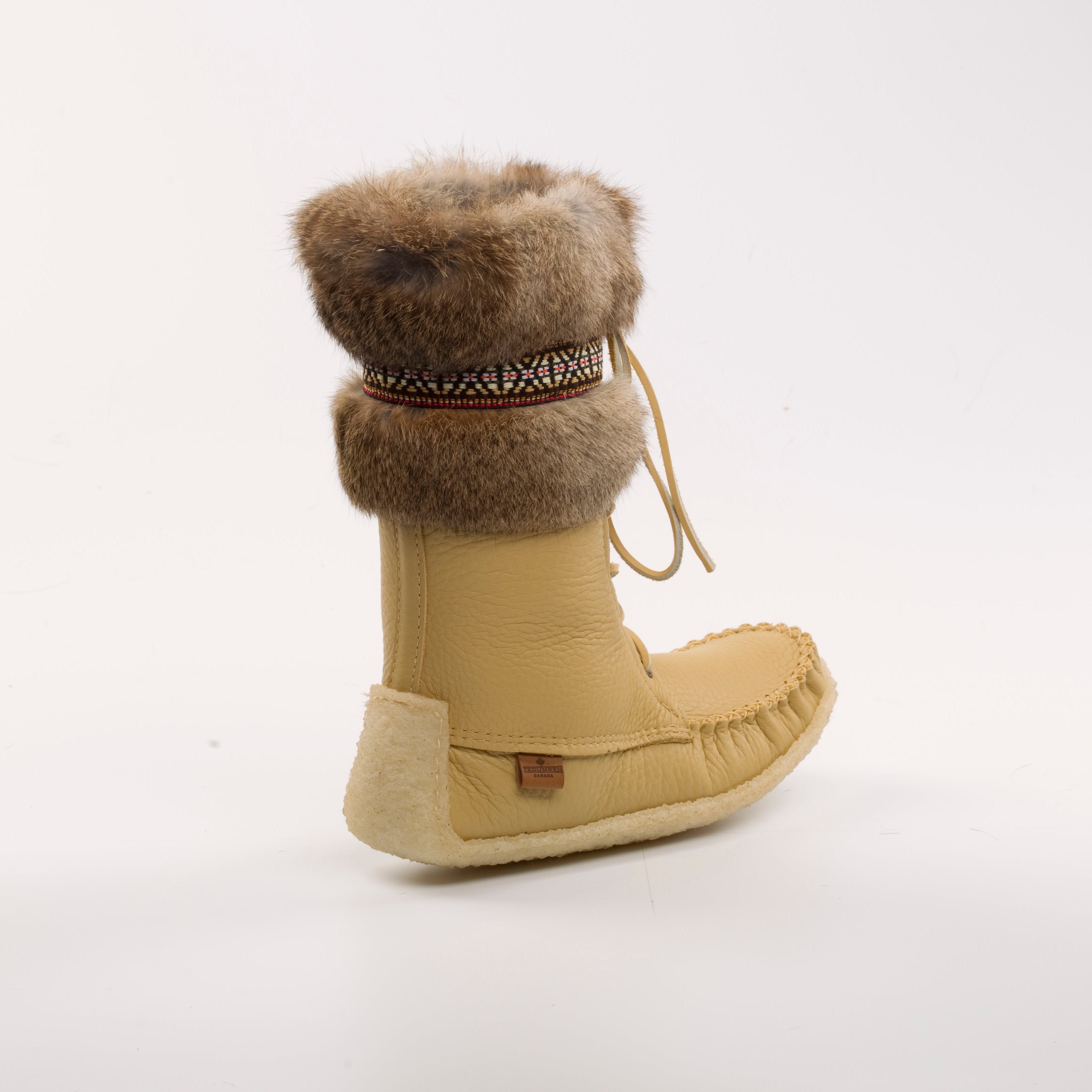 Beige moccasin boot with fur cuff on a white background