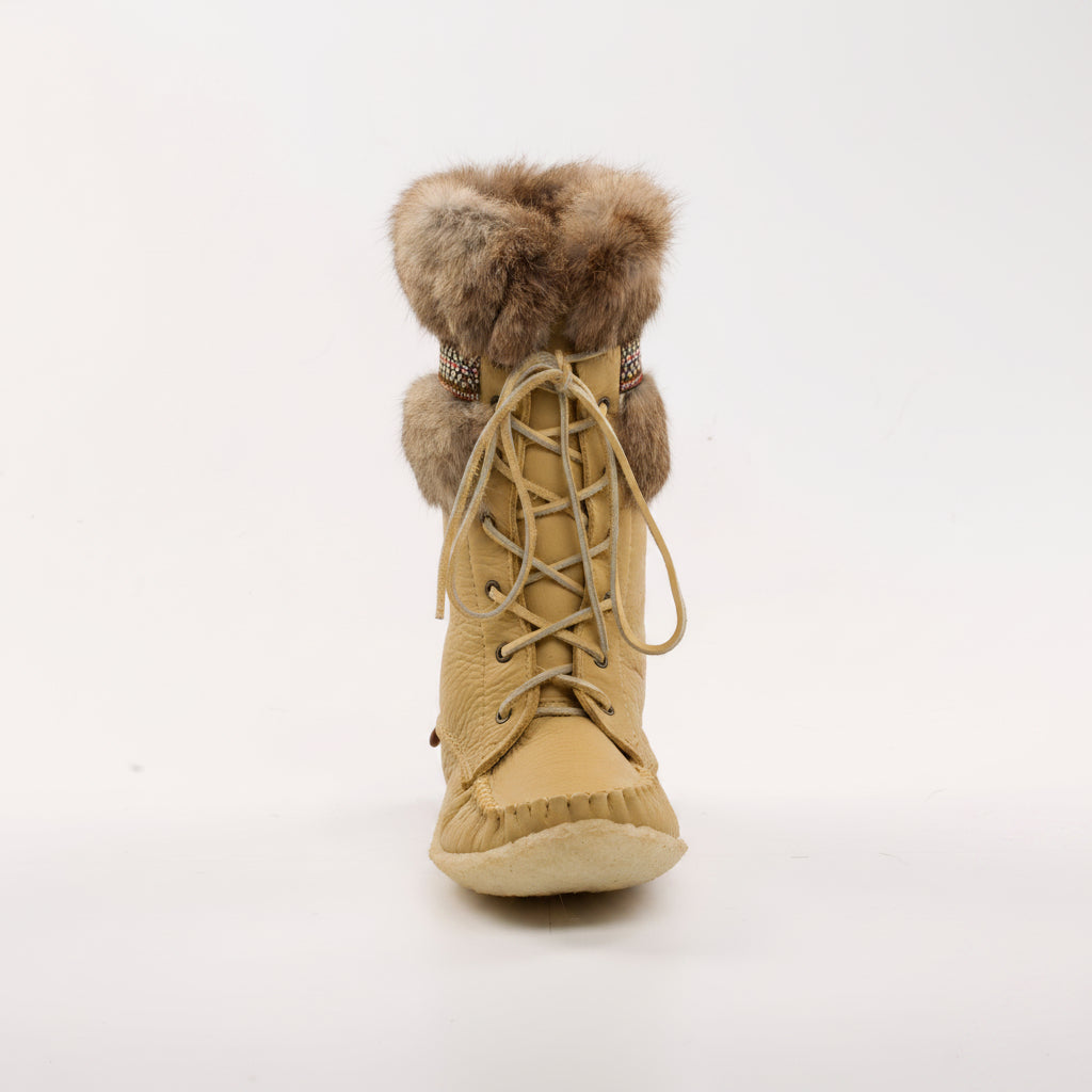 Beige winter boot with fur topper on a white background