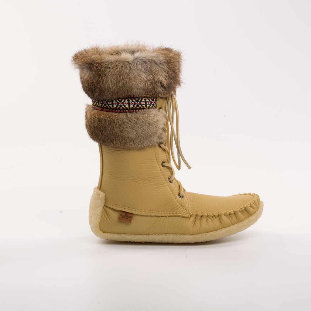 Tan winter boot with fur trim on a white background