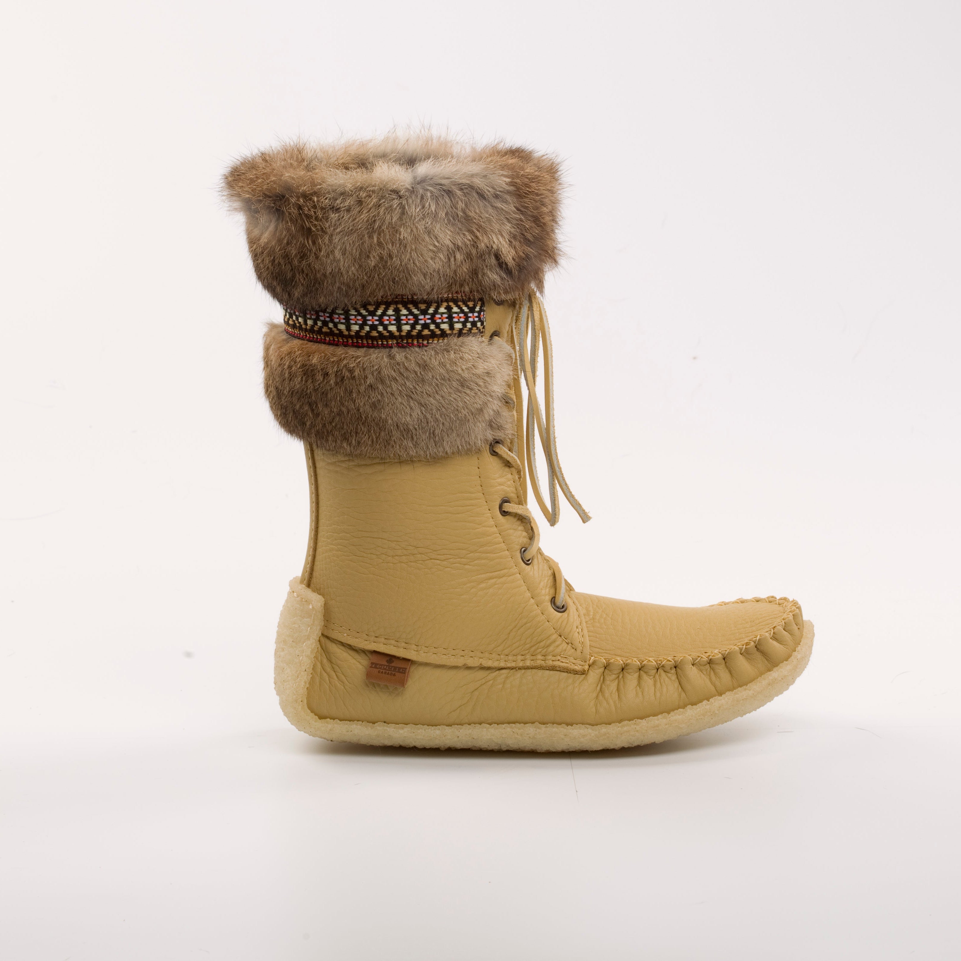 Tan winter boot with fur trim on a white background