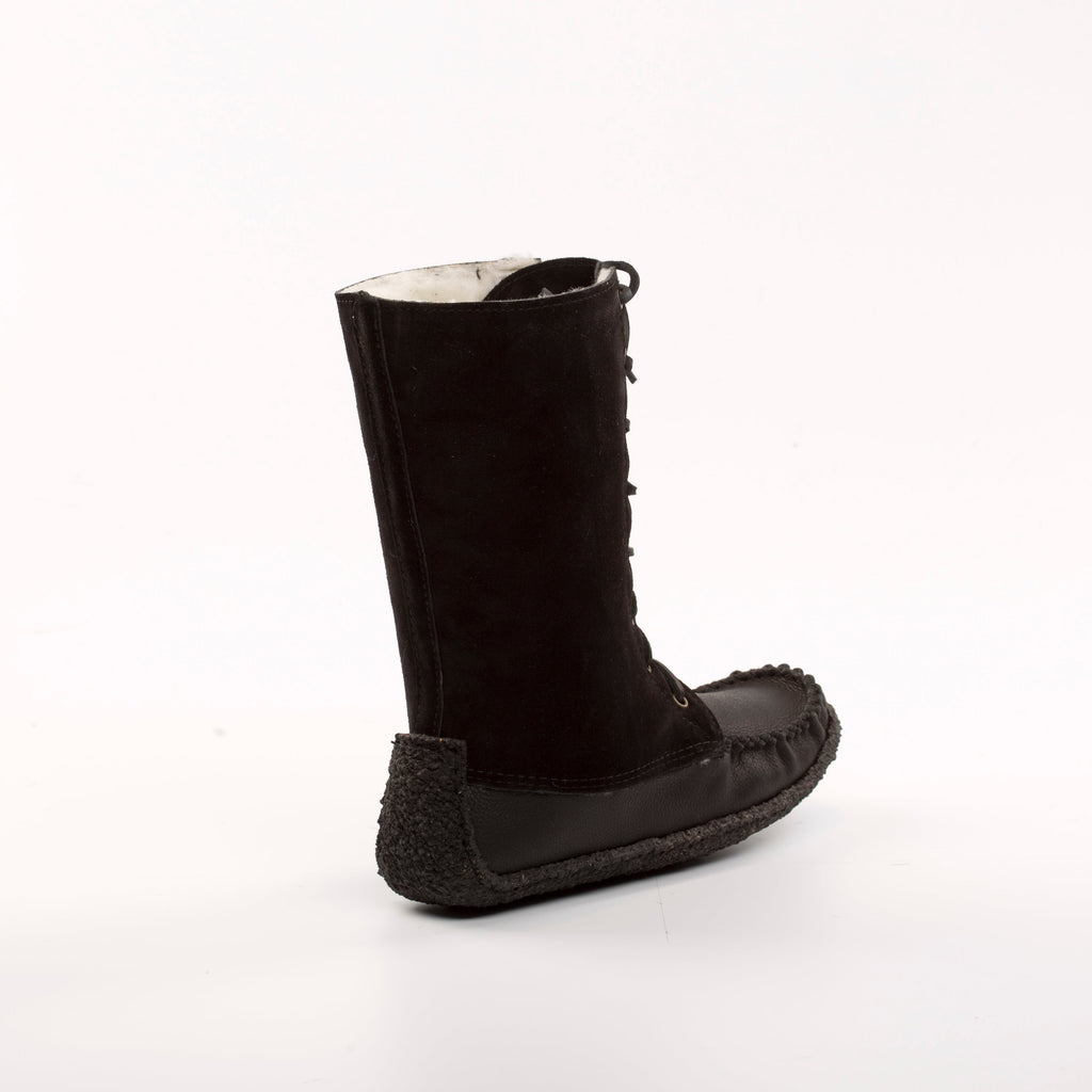 Black boot with textured sole on a white background