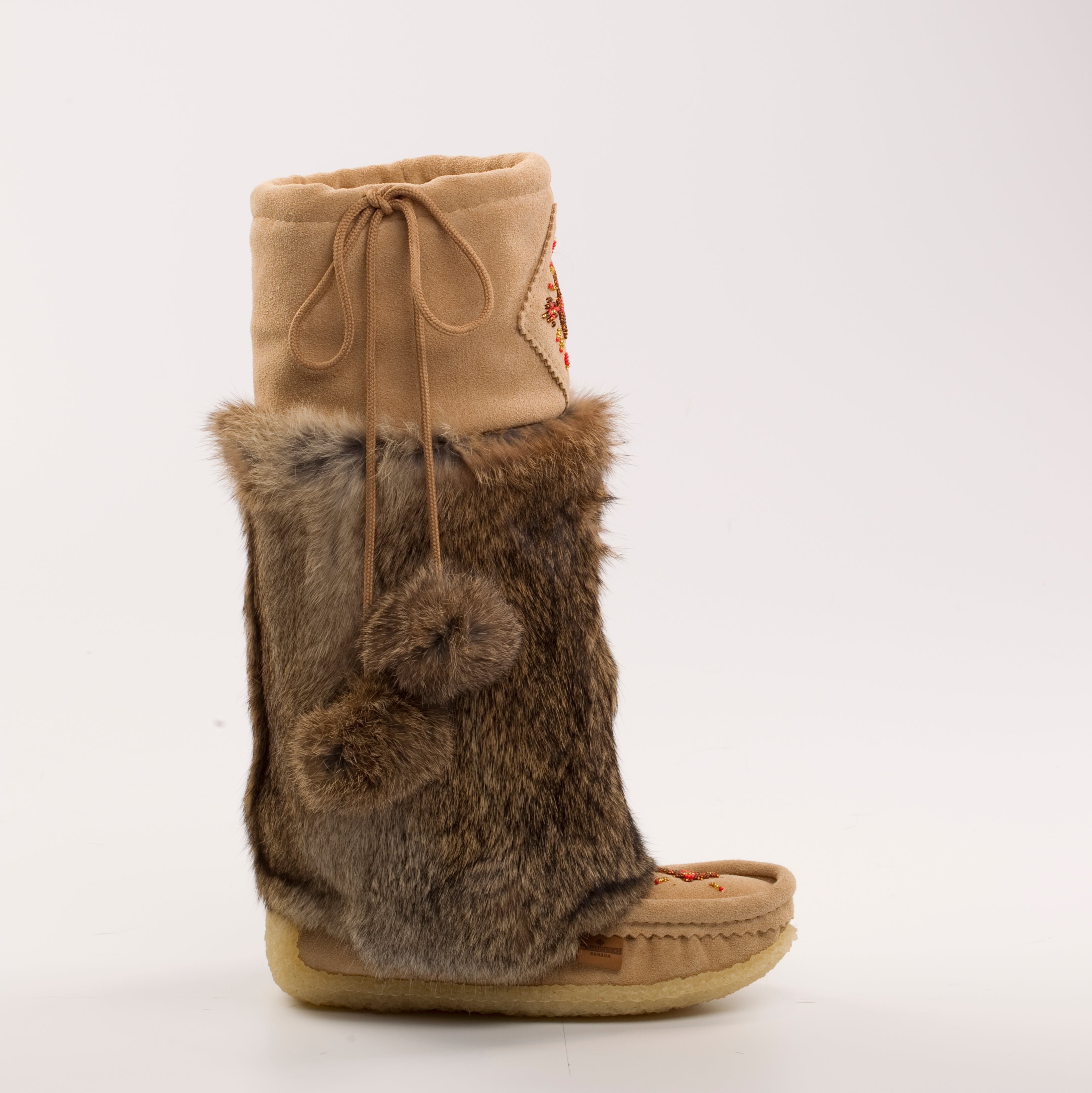 Brown fur-trimmed boot with beige top on a white background