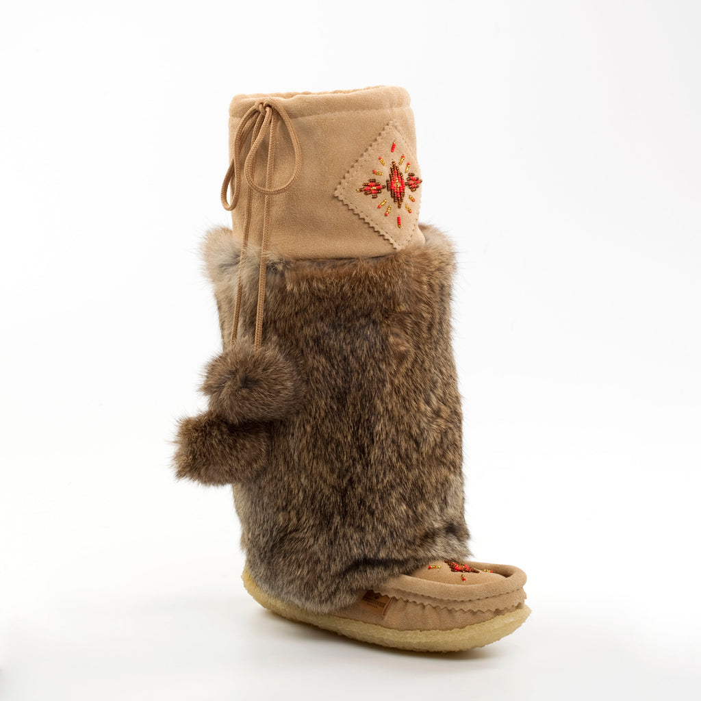 Brown fur mukluks boot with beige top and red pattern on a white background