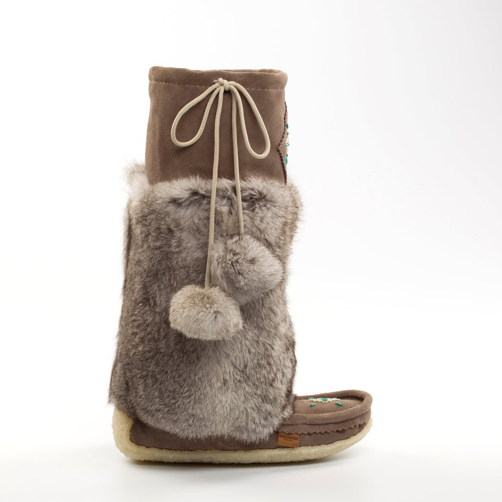 grey slip-on boots with fur trim and pom-poms on a white background