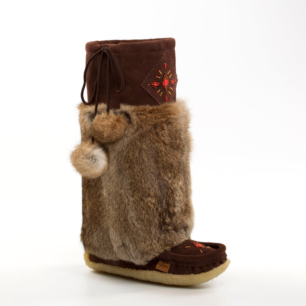 Brown furry boot with decorative top on a white background