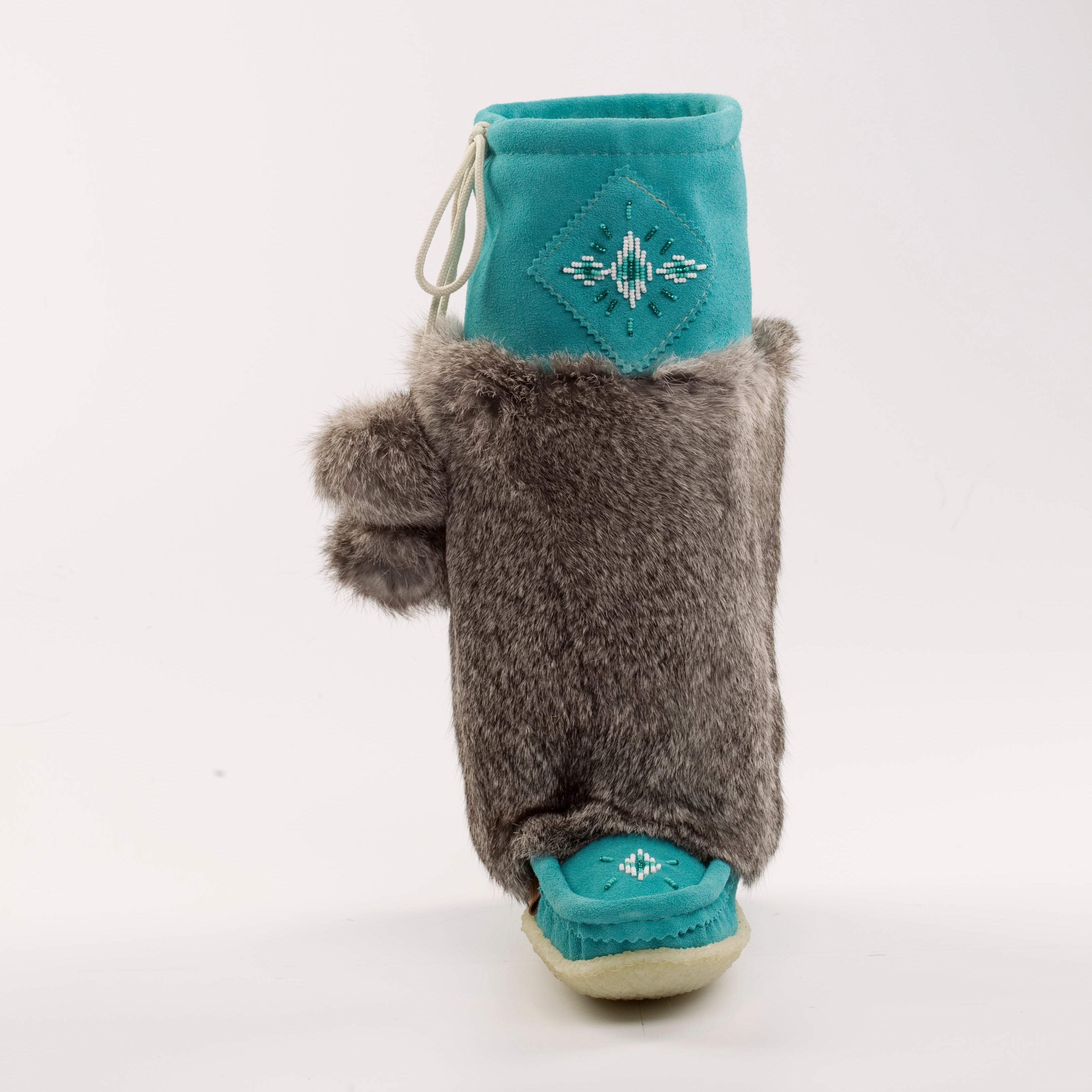 Gray fuzzy slipper with teal sole and top on a white background