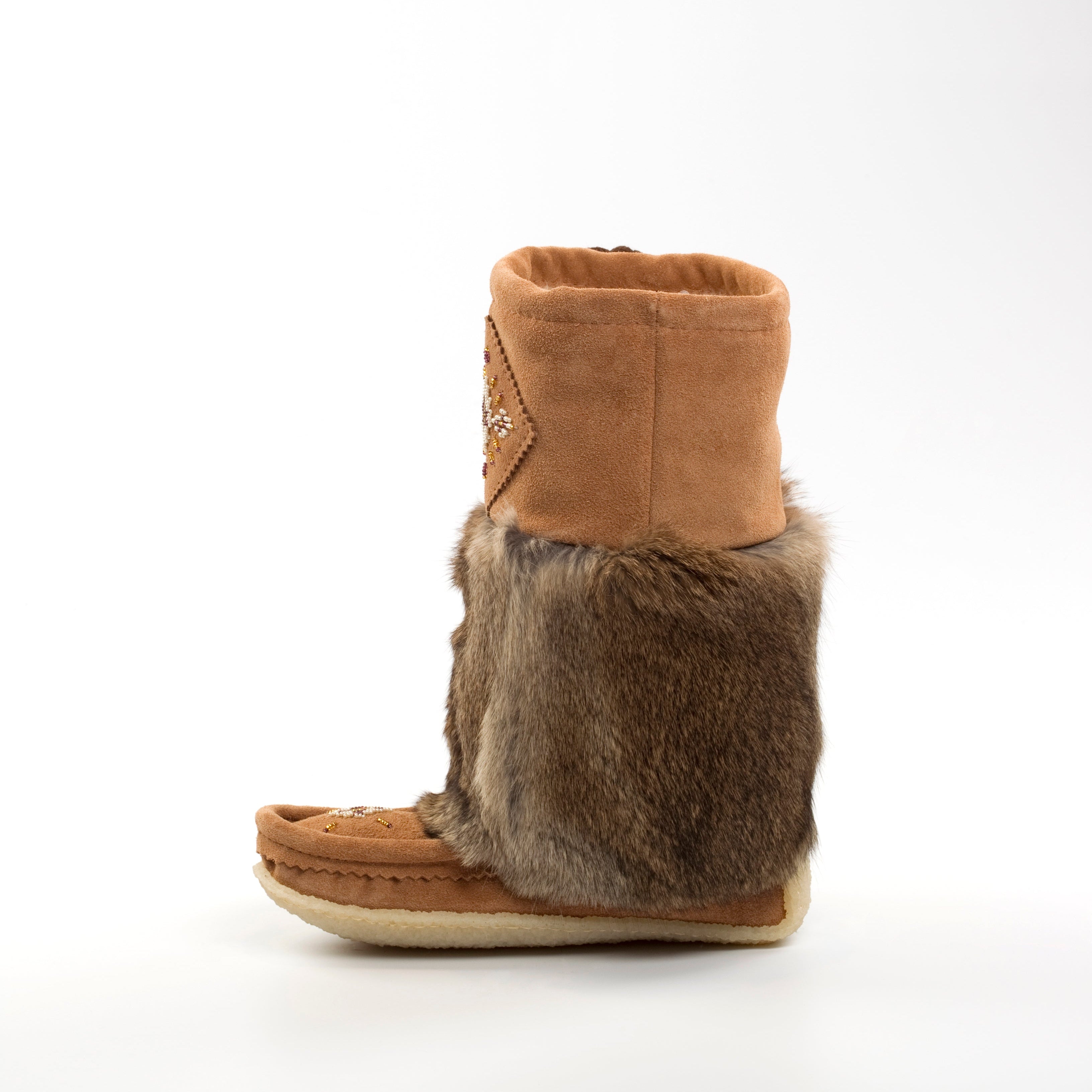 Brown mukluk boot with fur trim on a white background