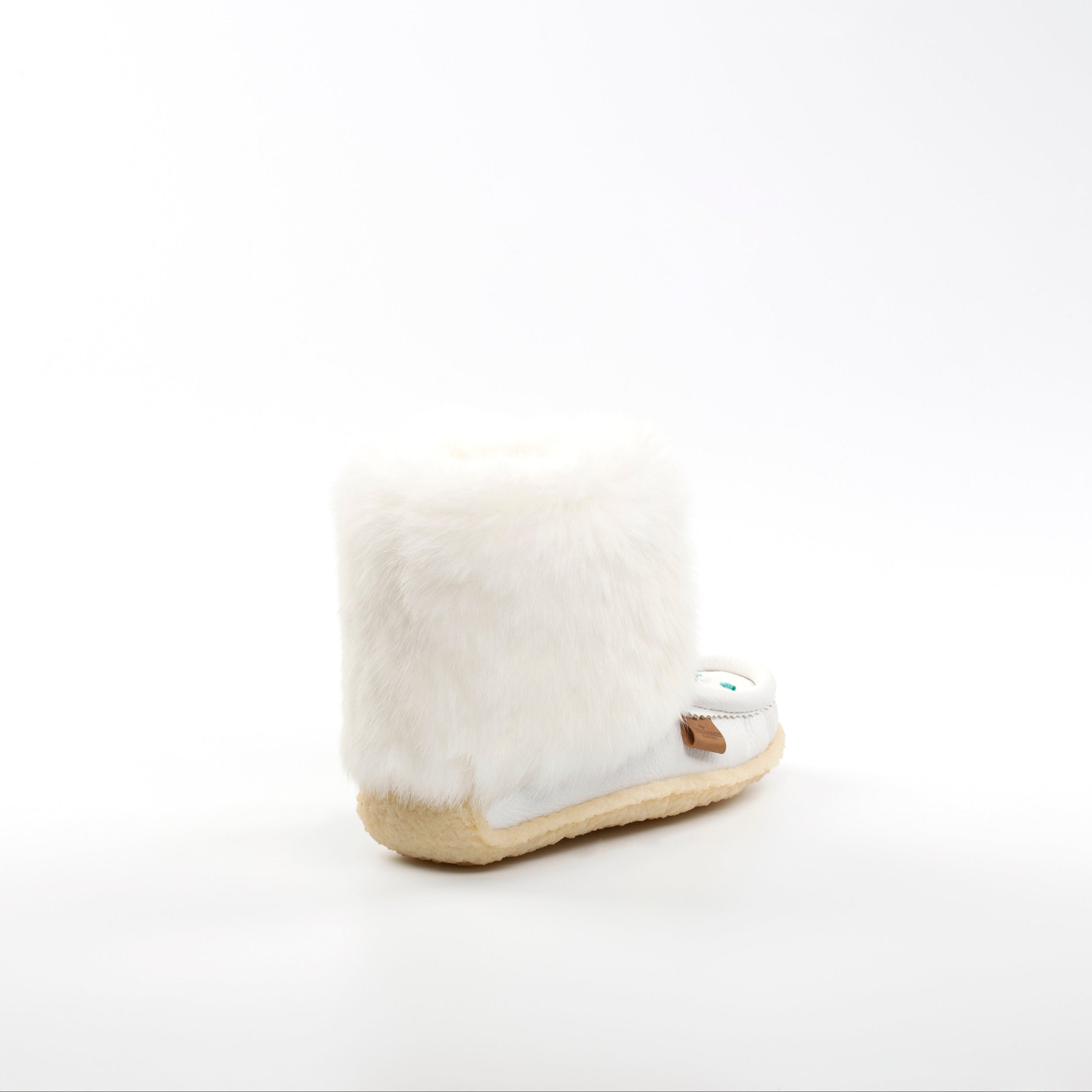 White fur mukluk boot on a white background