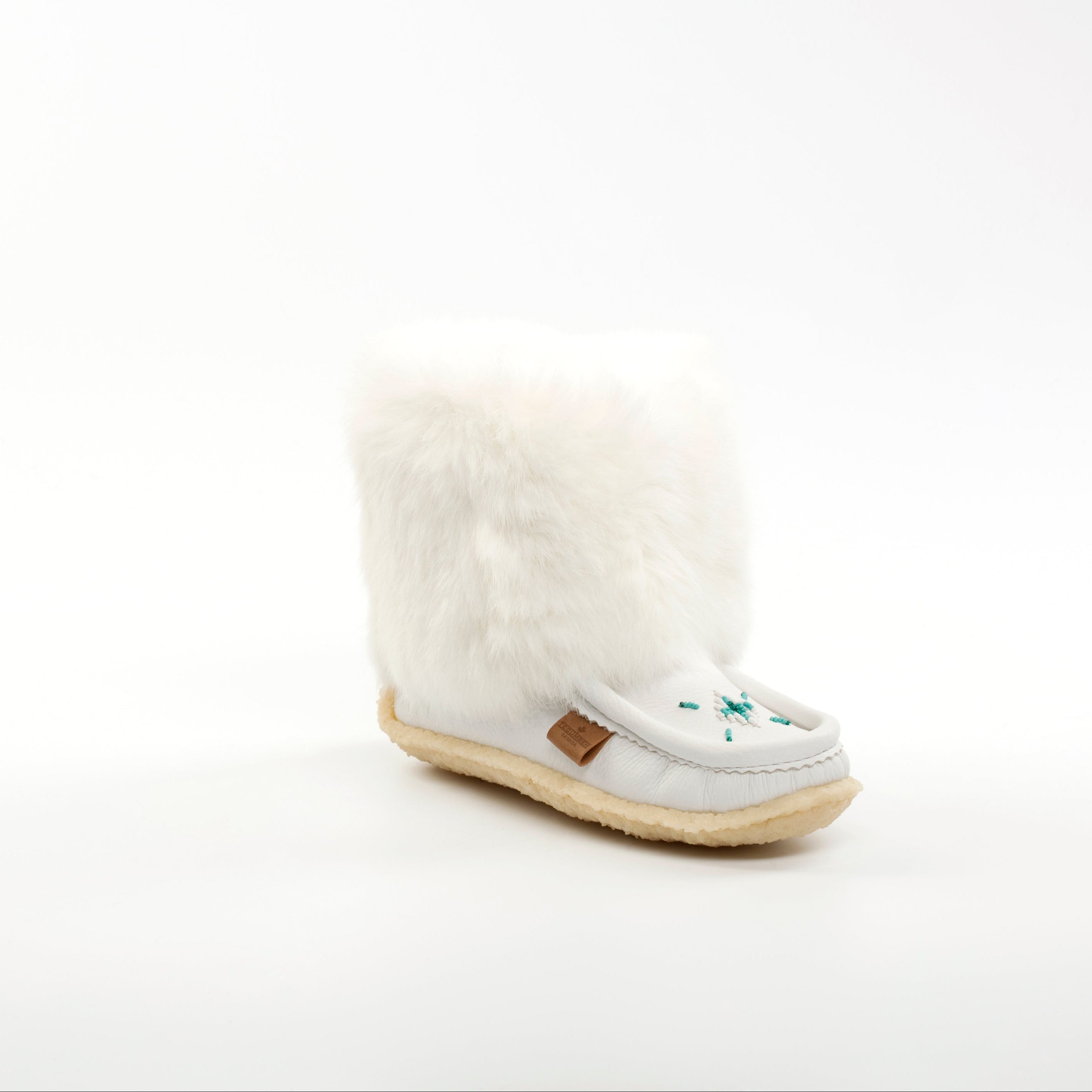 White mukluk with a cream sole on a white background