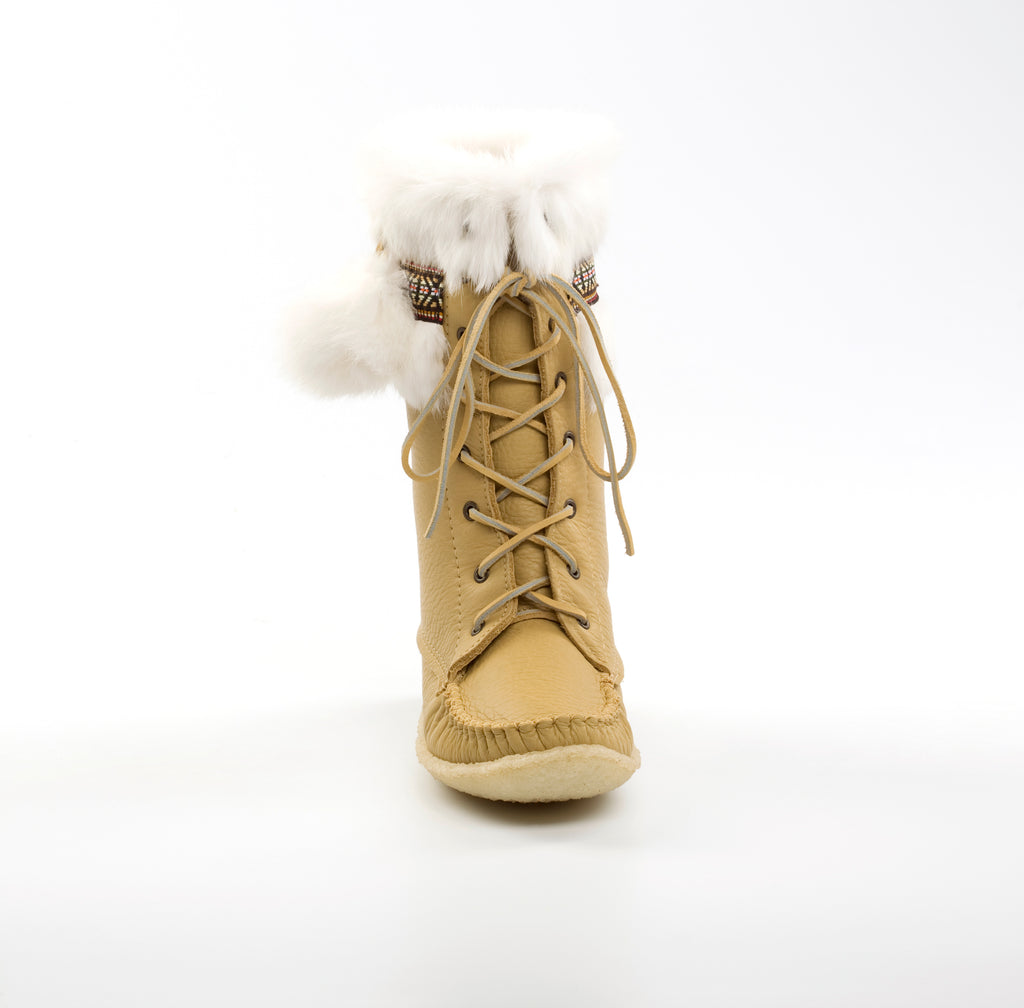 Tan winter boot with fur lining on a white background