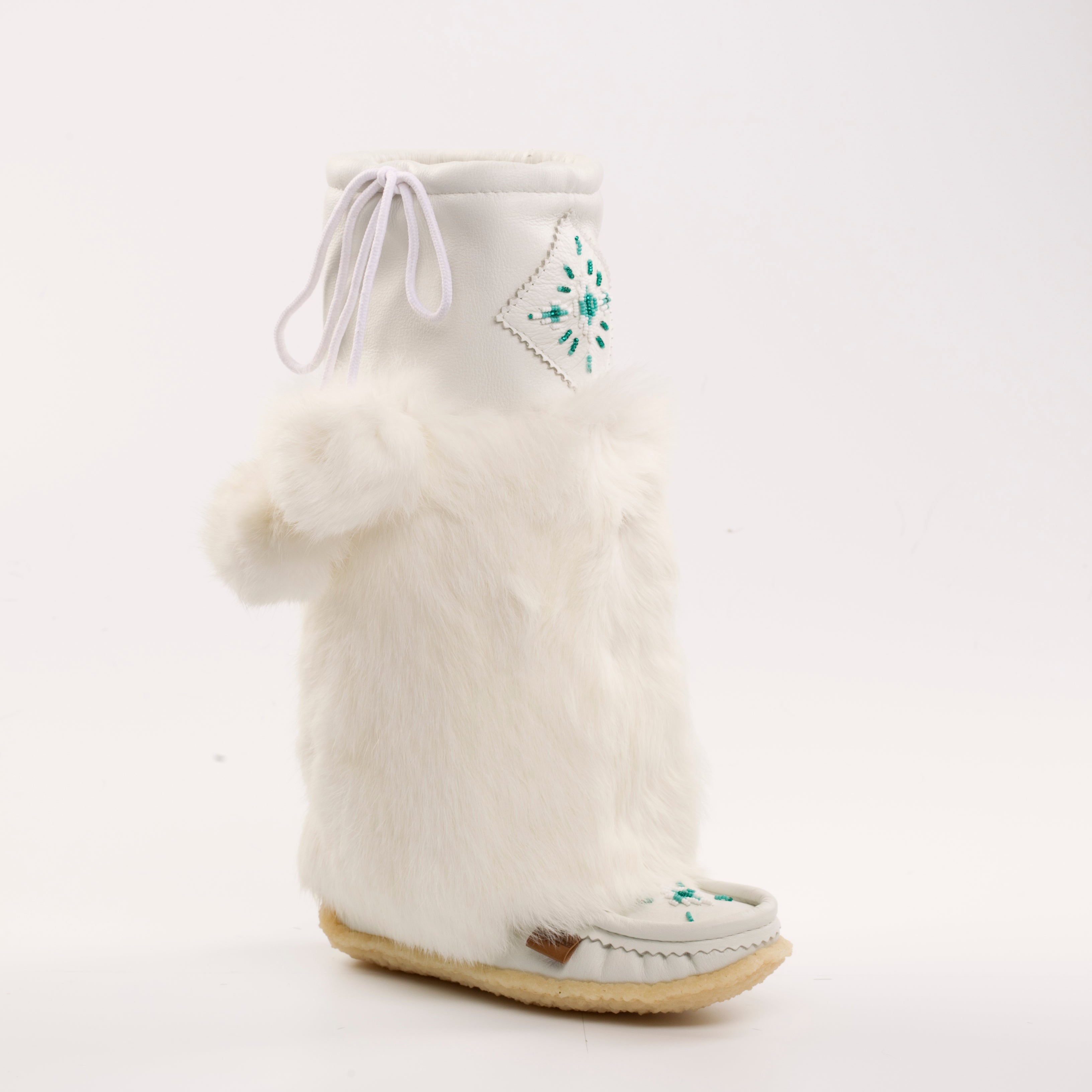 White mukluks-style boot with fur trim on a white background
