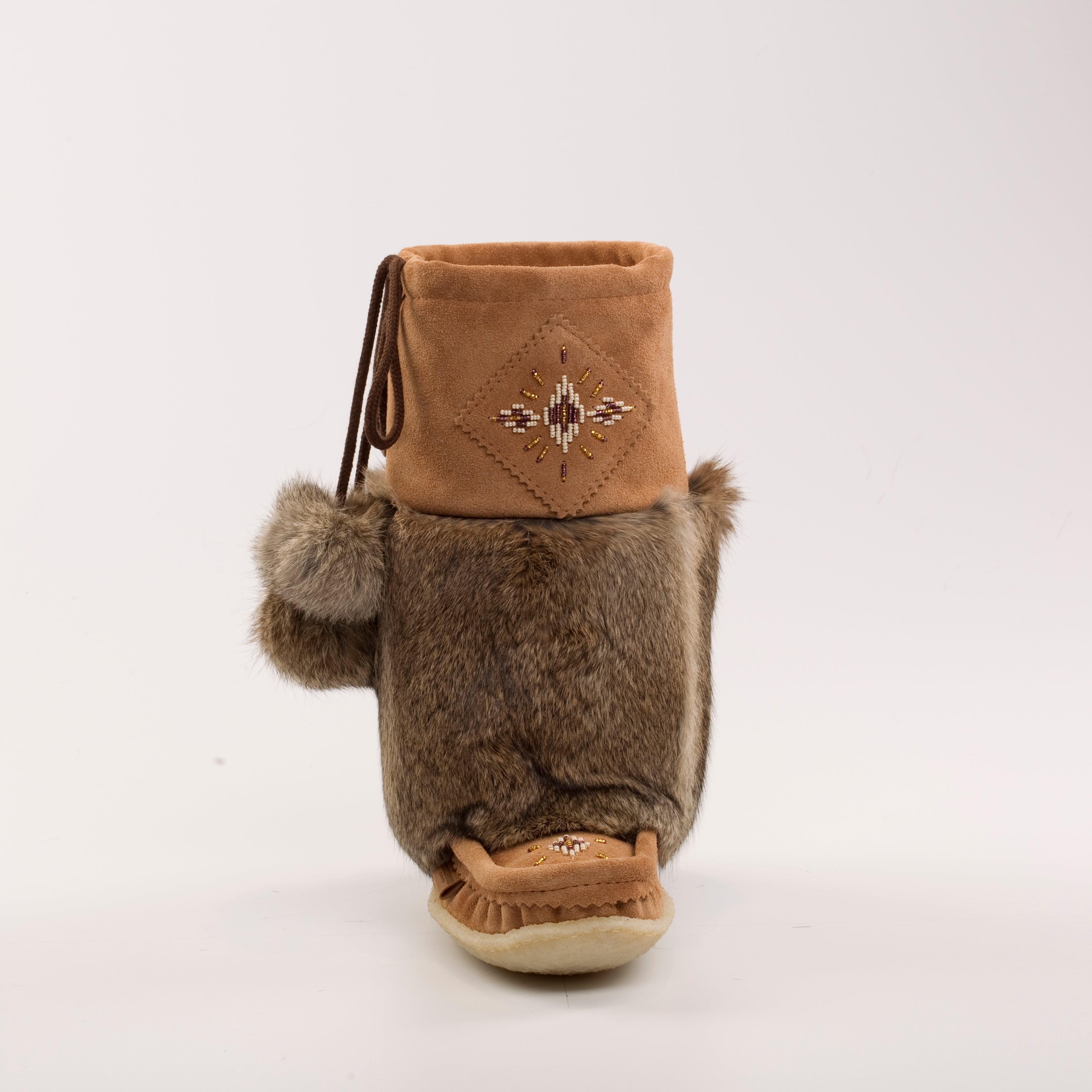 Brown mukluks with fur on a white background