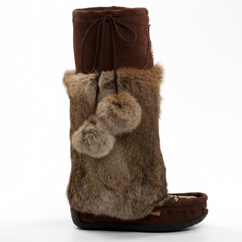 Brown boot with fur trim and pom-poms on a white background