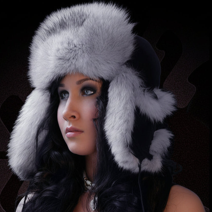 Woman wearing a gray fur hat with ear flaps against a dark background
