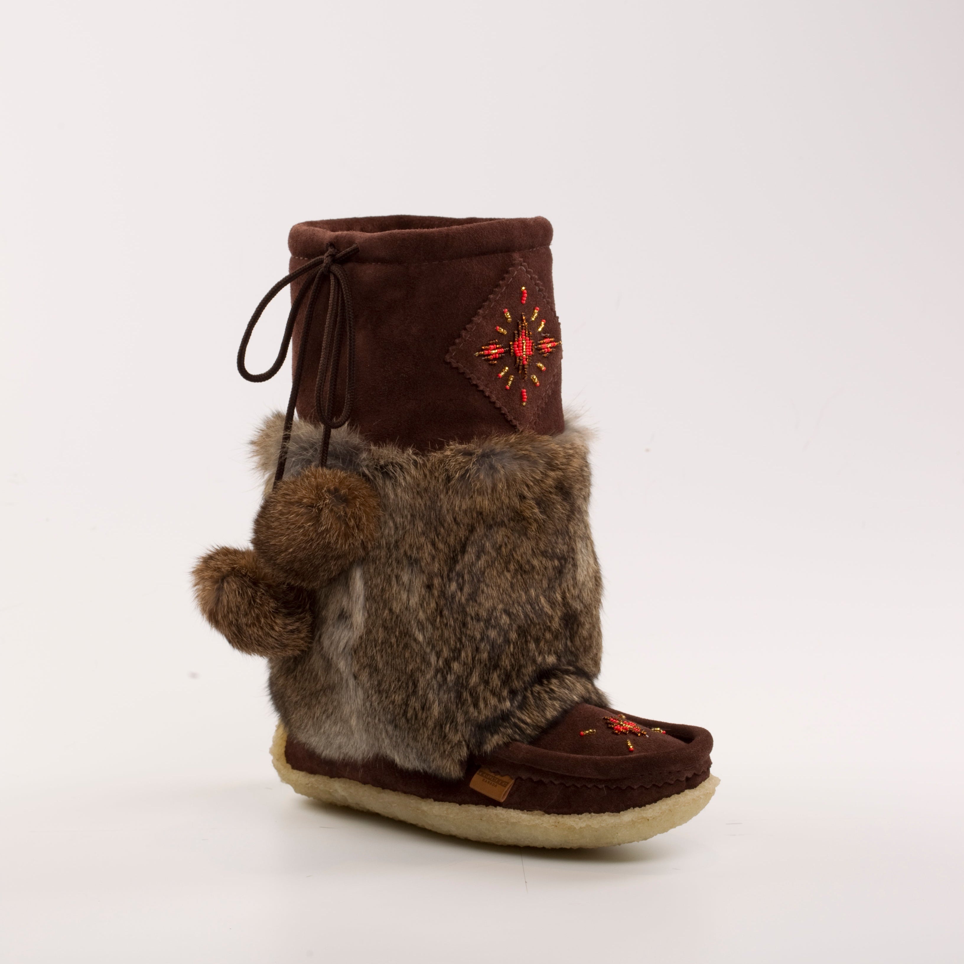 Brown mukluks with fur lining on a white background
