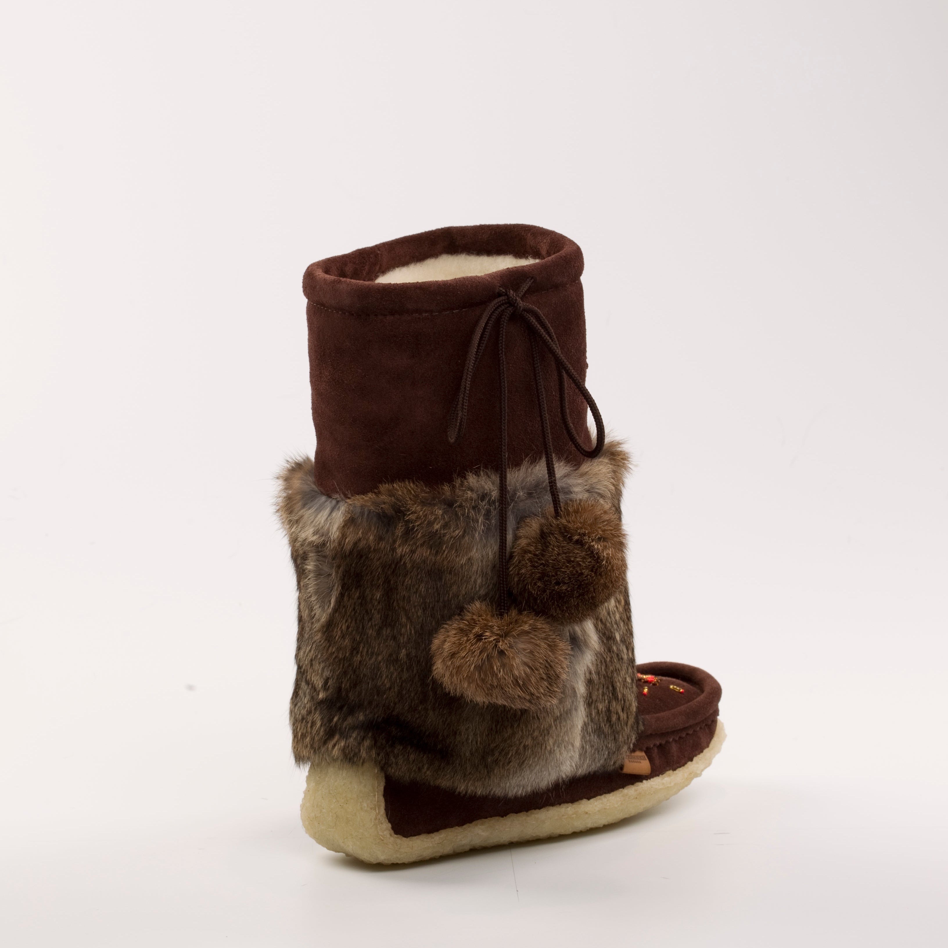 Brown mukluks with fur trim on a white background