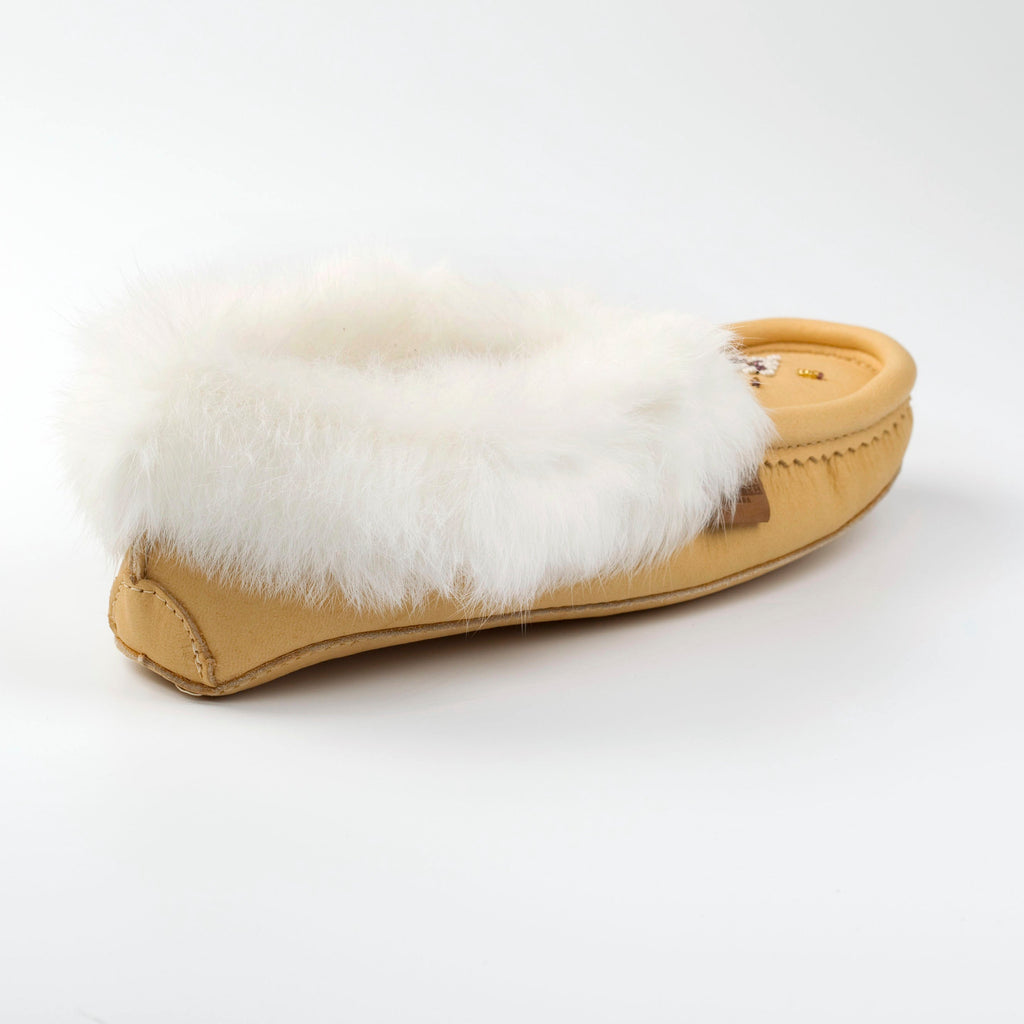 Tan slipper with white fur lining on a white background