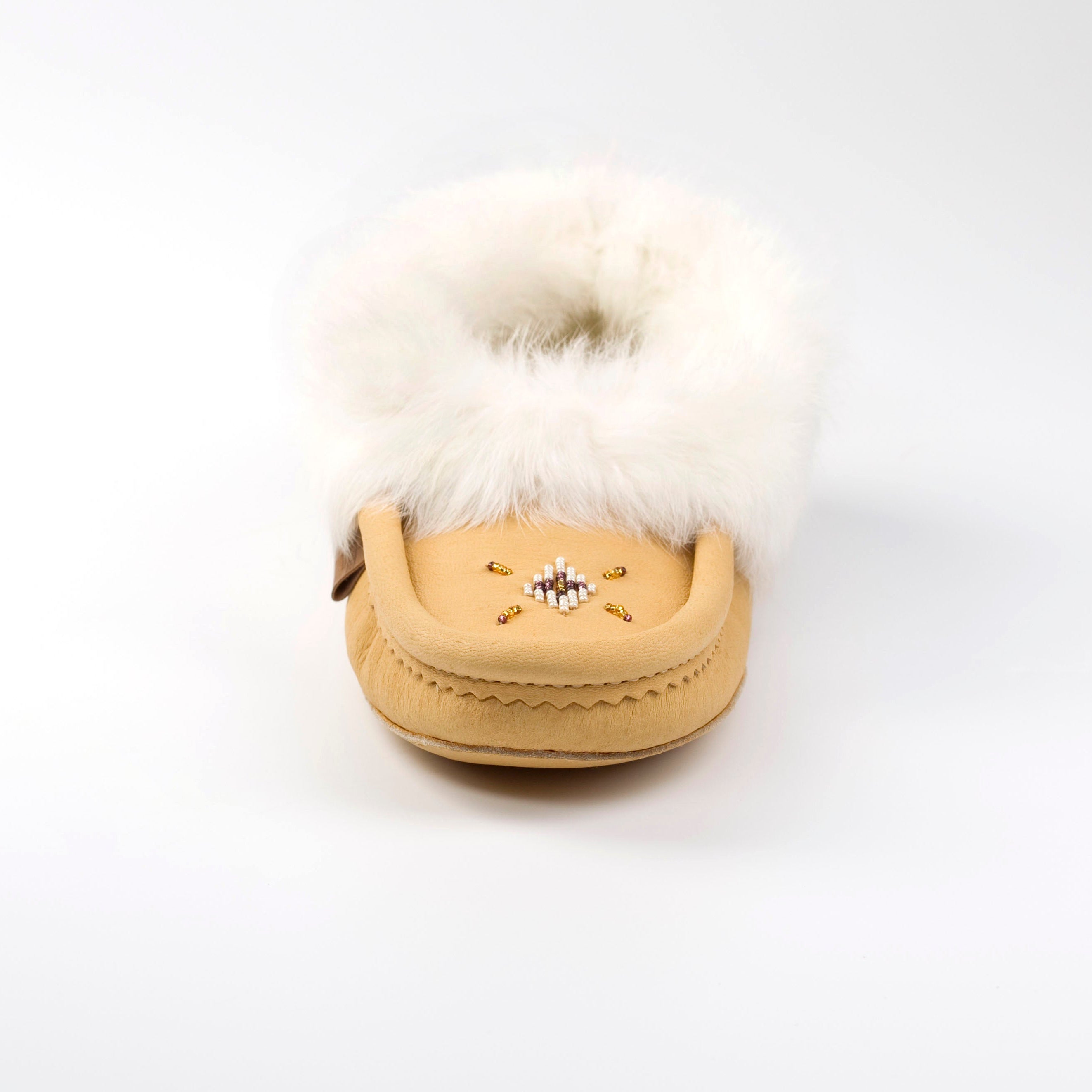 moosehide moccasin slipper with white fur on a white background