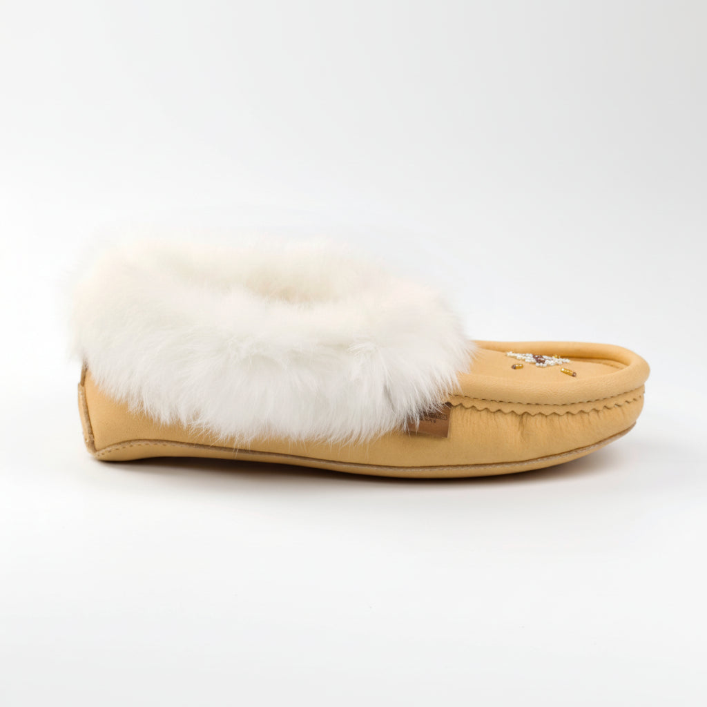 Tan slipper with white fur lining on a white background