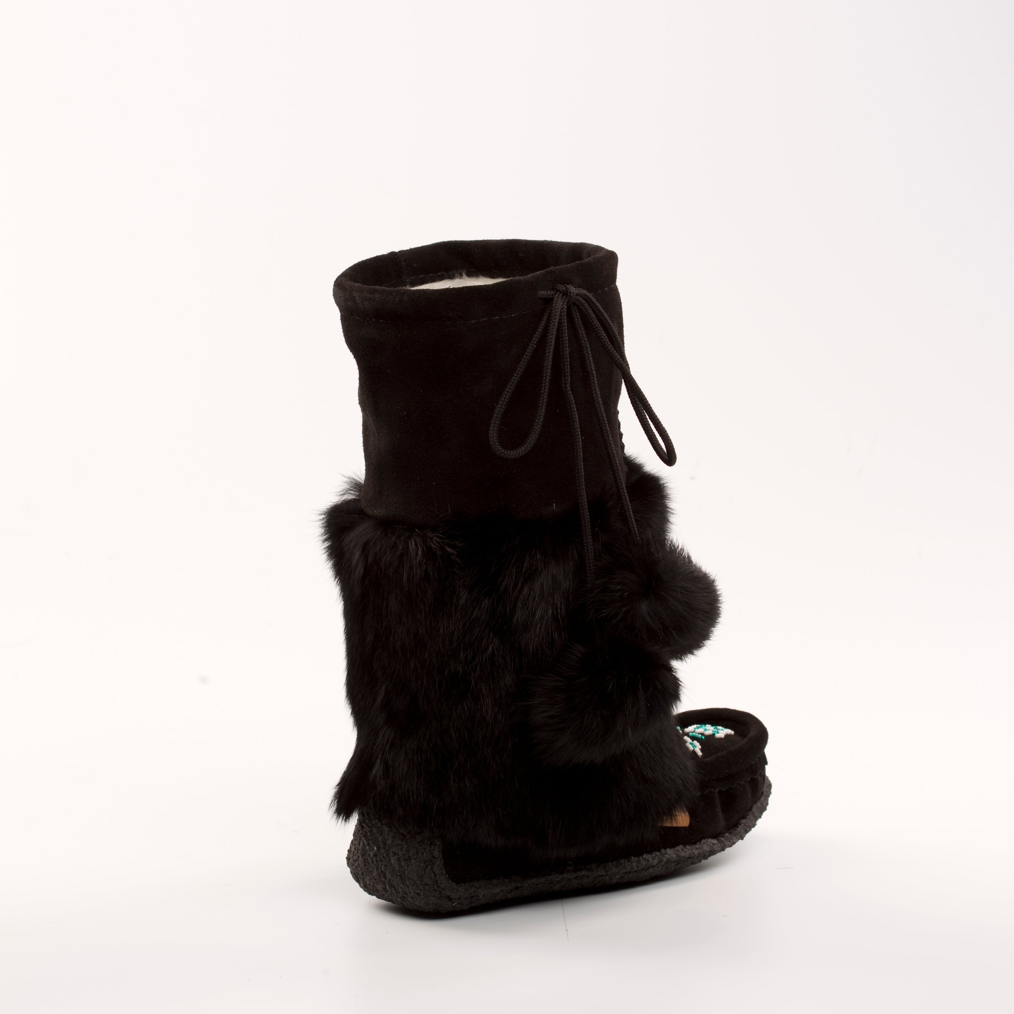 Black mukluk fur boot with a white background