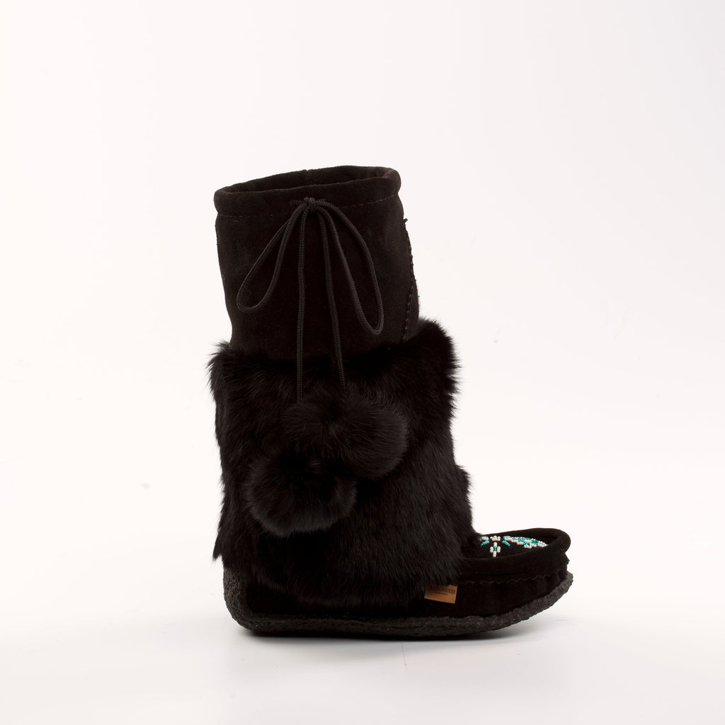 Black fur mukluk boot with a bow on a white background