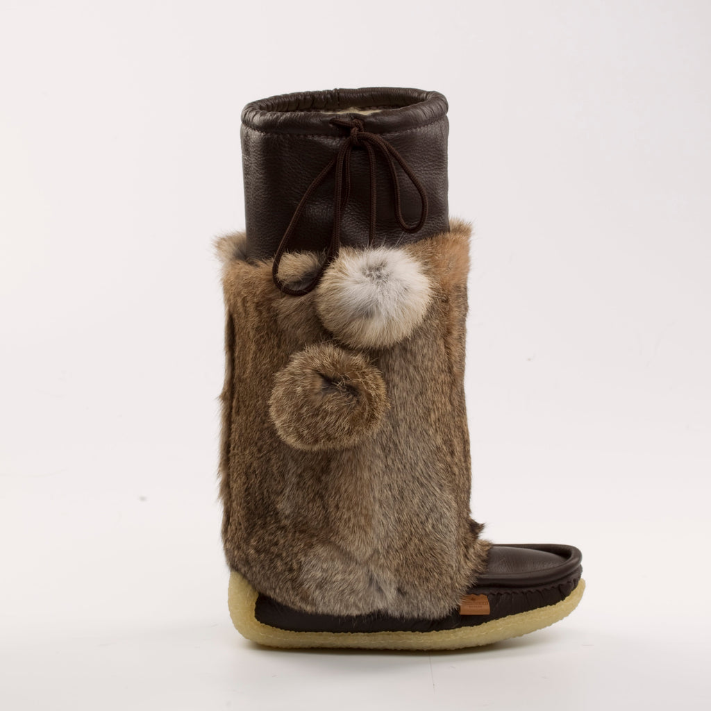 Brown fur boot with pom-poms on a white background