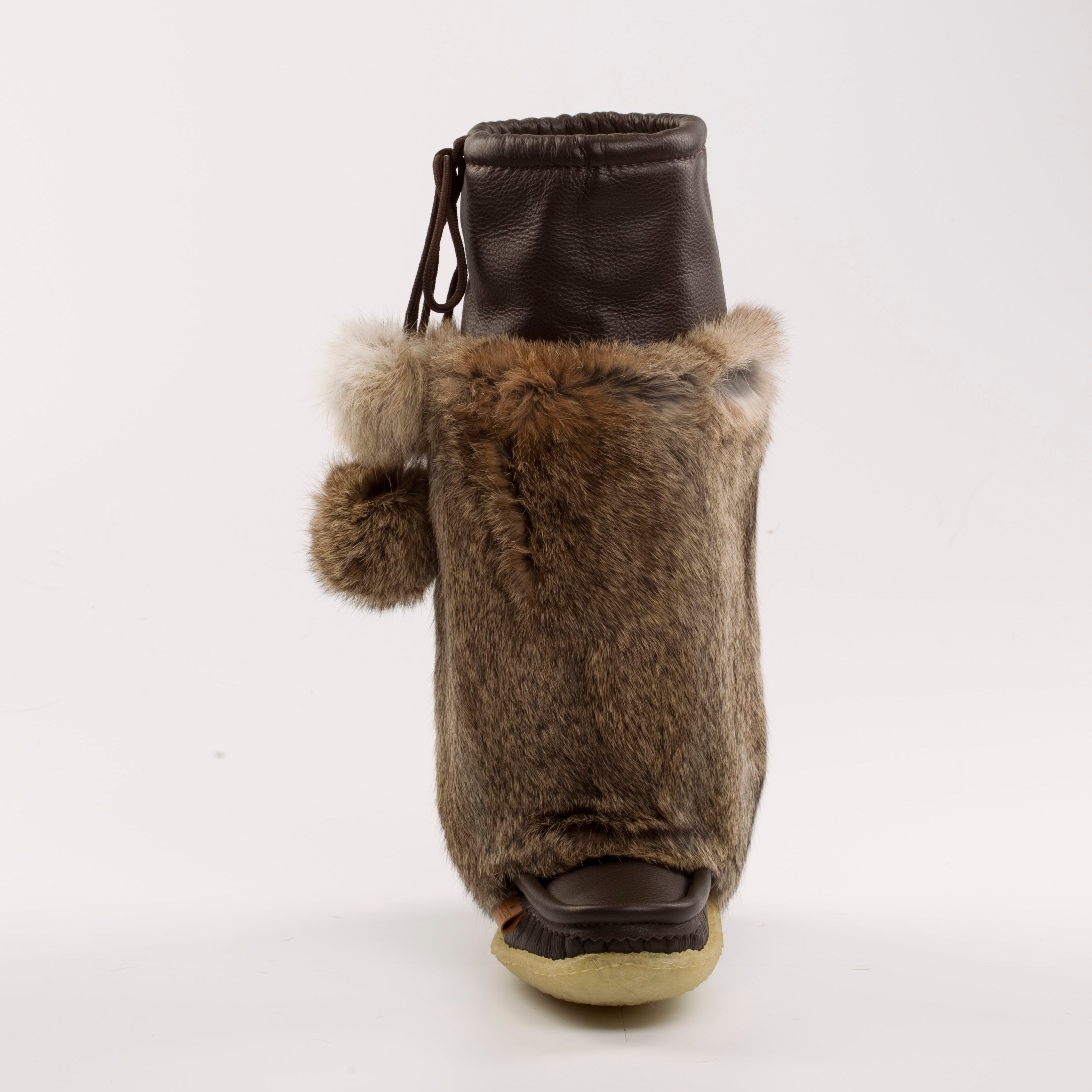 Brown fur mukluk boot on a white background