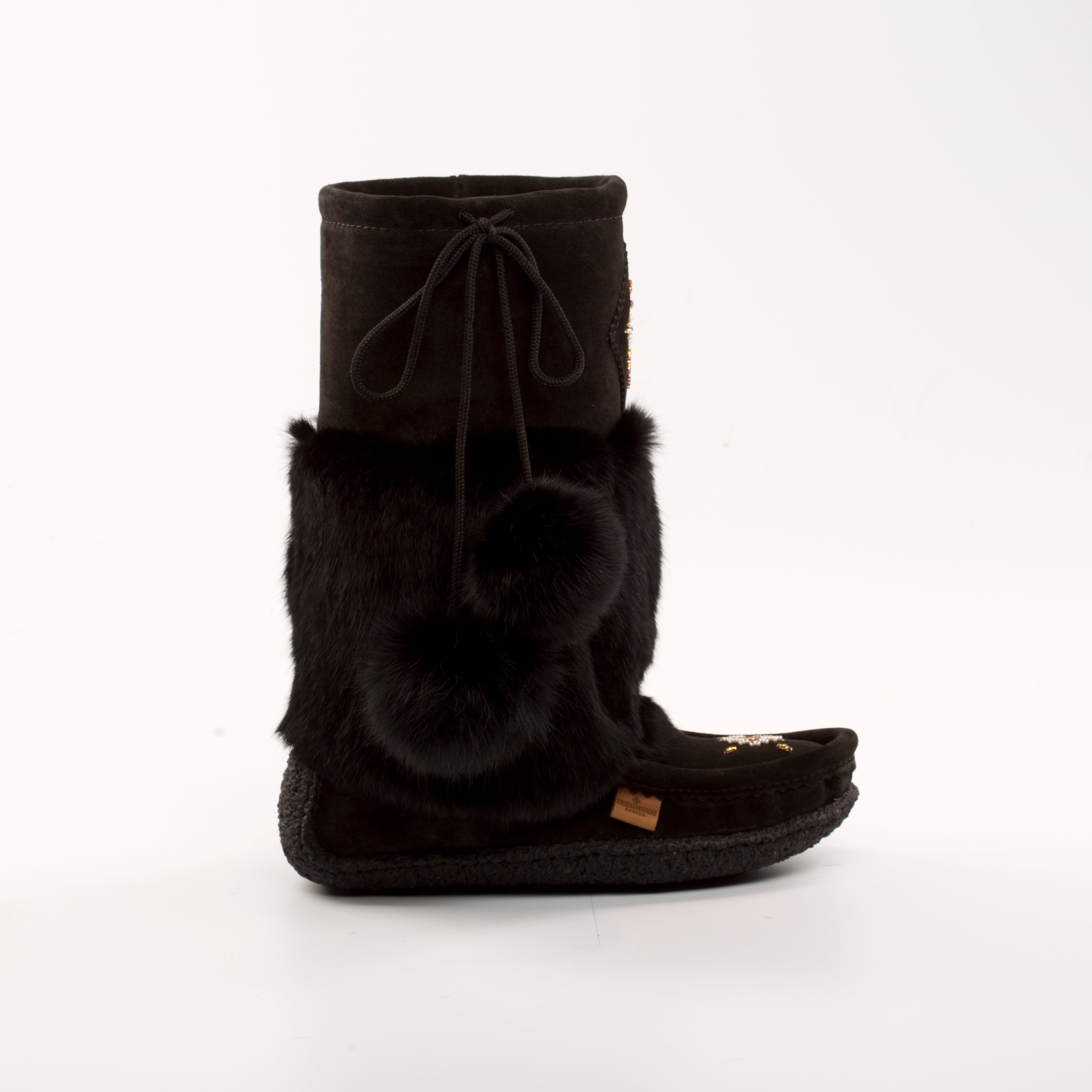 Black fuzzy mukluk boot with fur trim on a white background